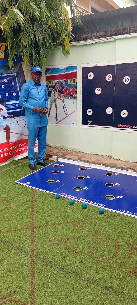 The Bomsy Target Bowling board set up on turf, numbered holes visible