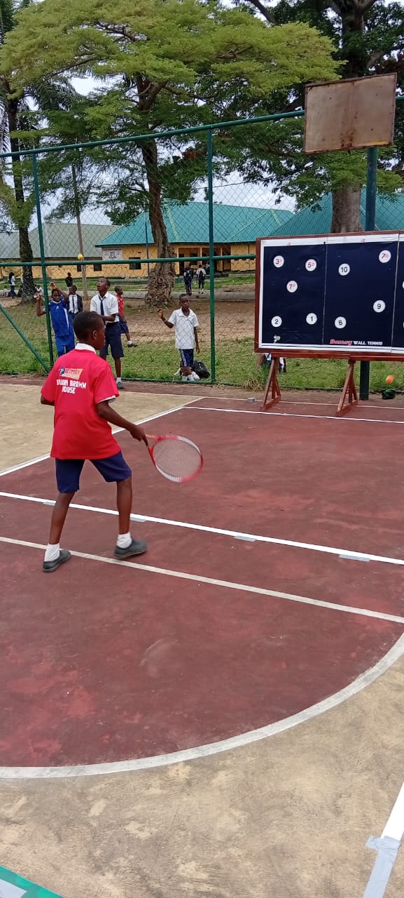 Player from Bauari Brown House playing against the wall board