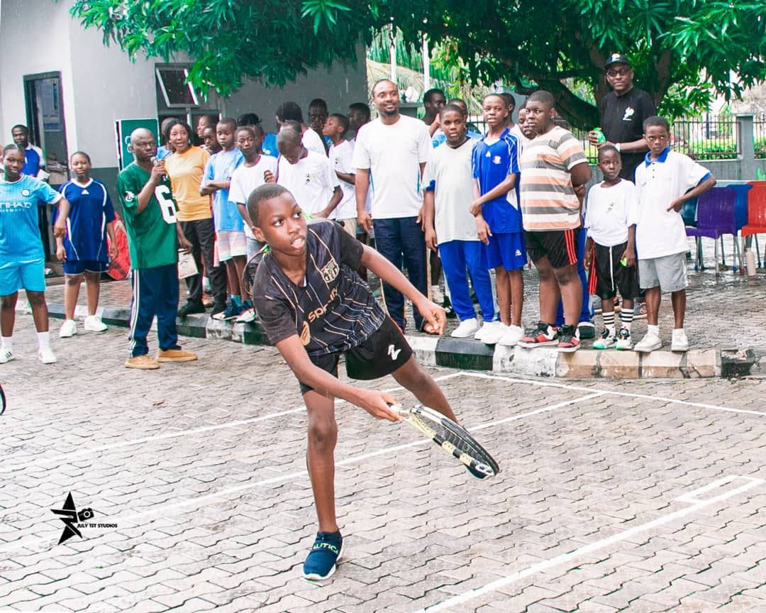 Player swinging with a crowd of students watching
