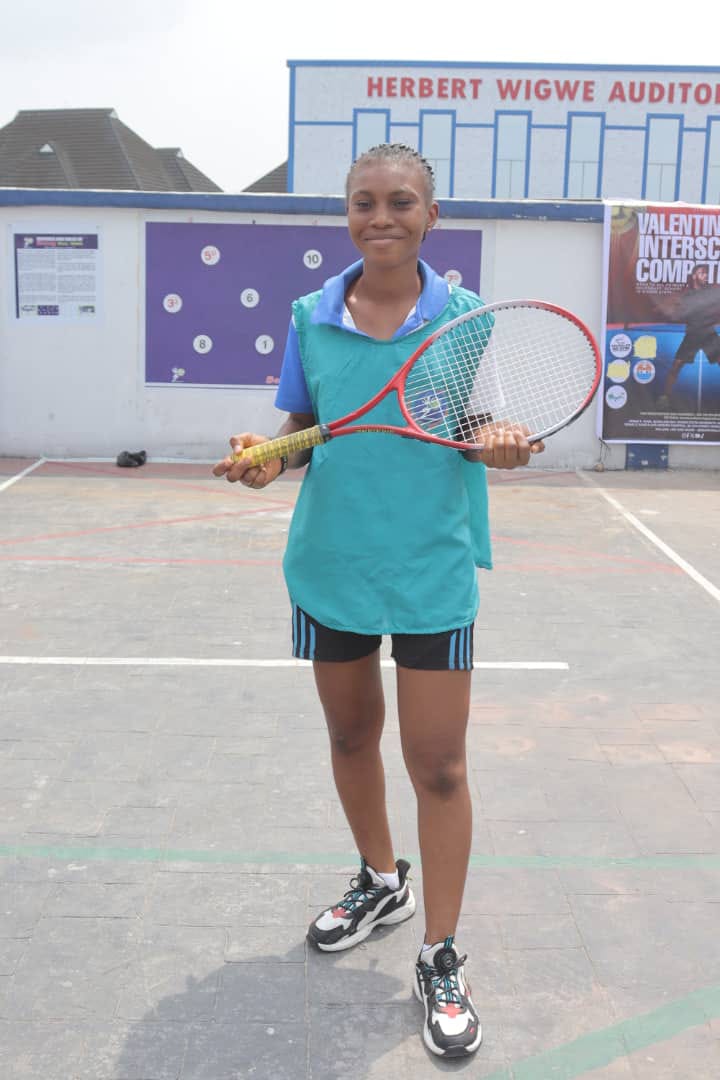 Player posed with racquet in front of the Bomsy Wall Tennis board
